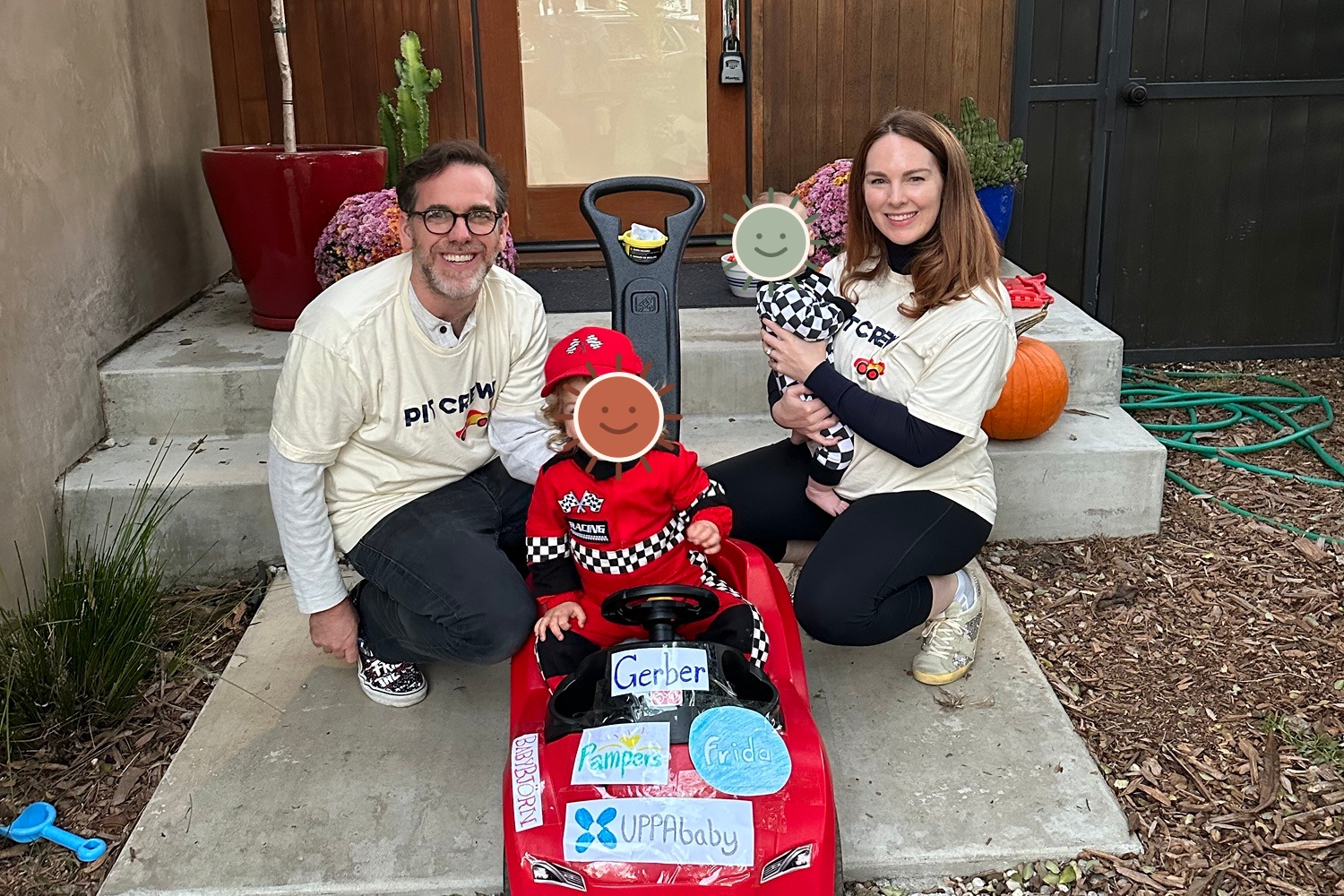 The family dressed as a playful racing pit crew for Halloween, with the children's faces covered by illustrated stickers for privacy.
